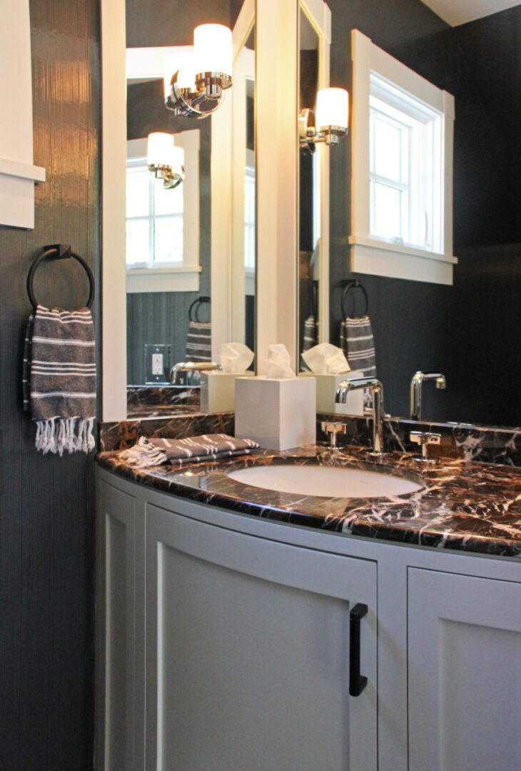 A bathroom with a sink and mirror in it