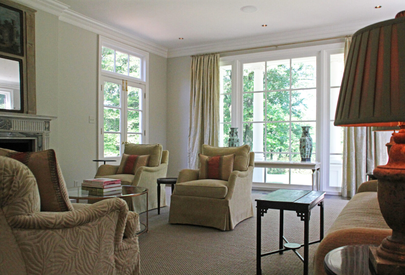 A living room with two chairs and tables