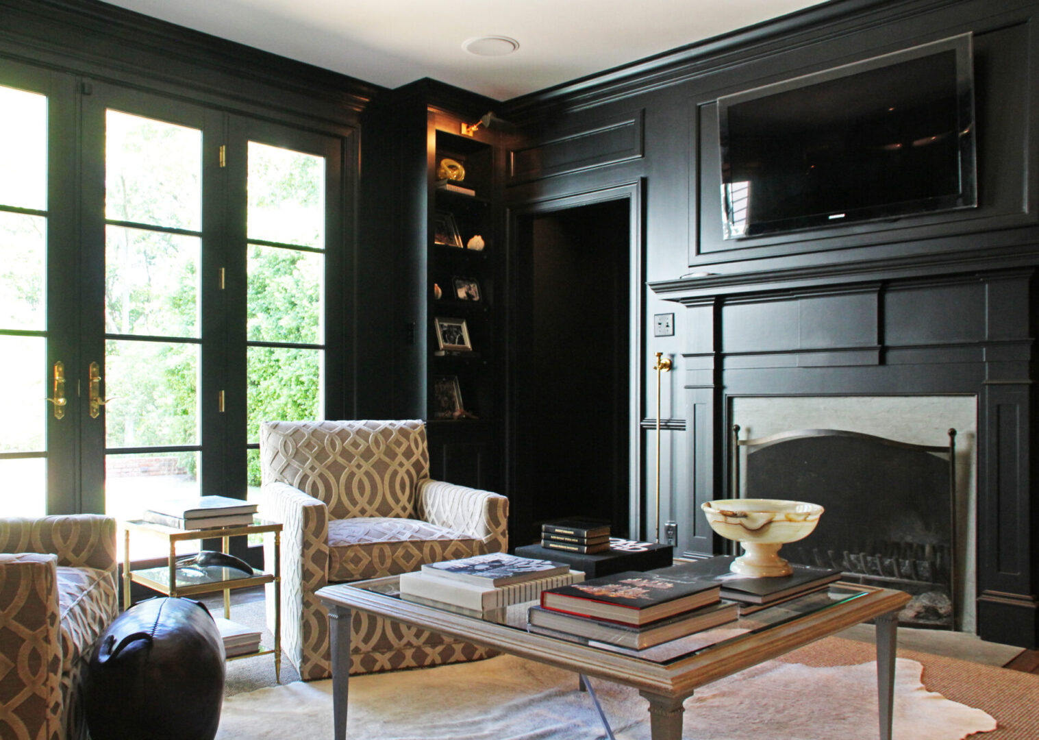 A living room with black walls and fireplace.