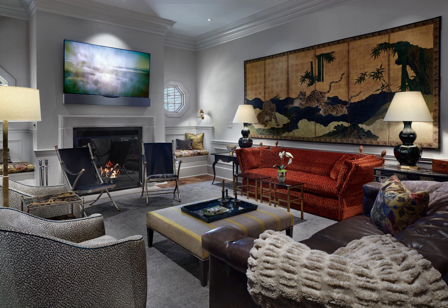 A living room with couches, chairs and a fire place.