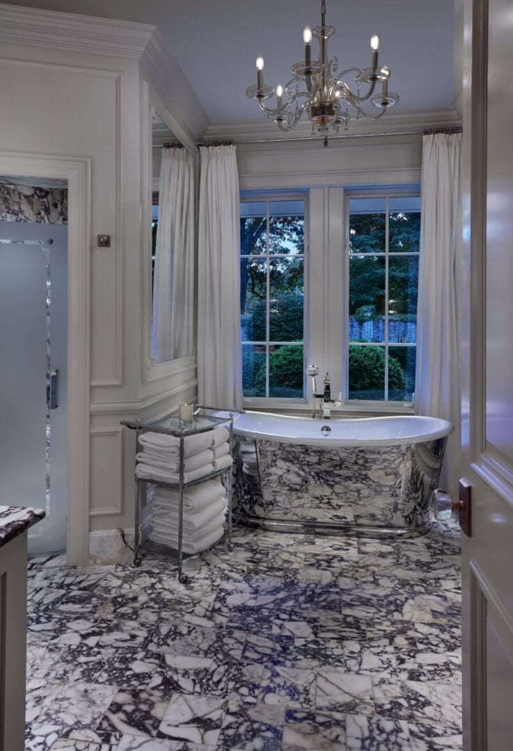 A bathroom with a tub, toilet and shower.