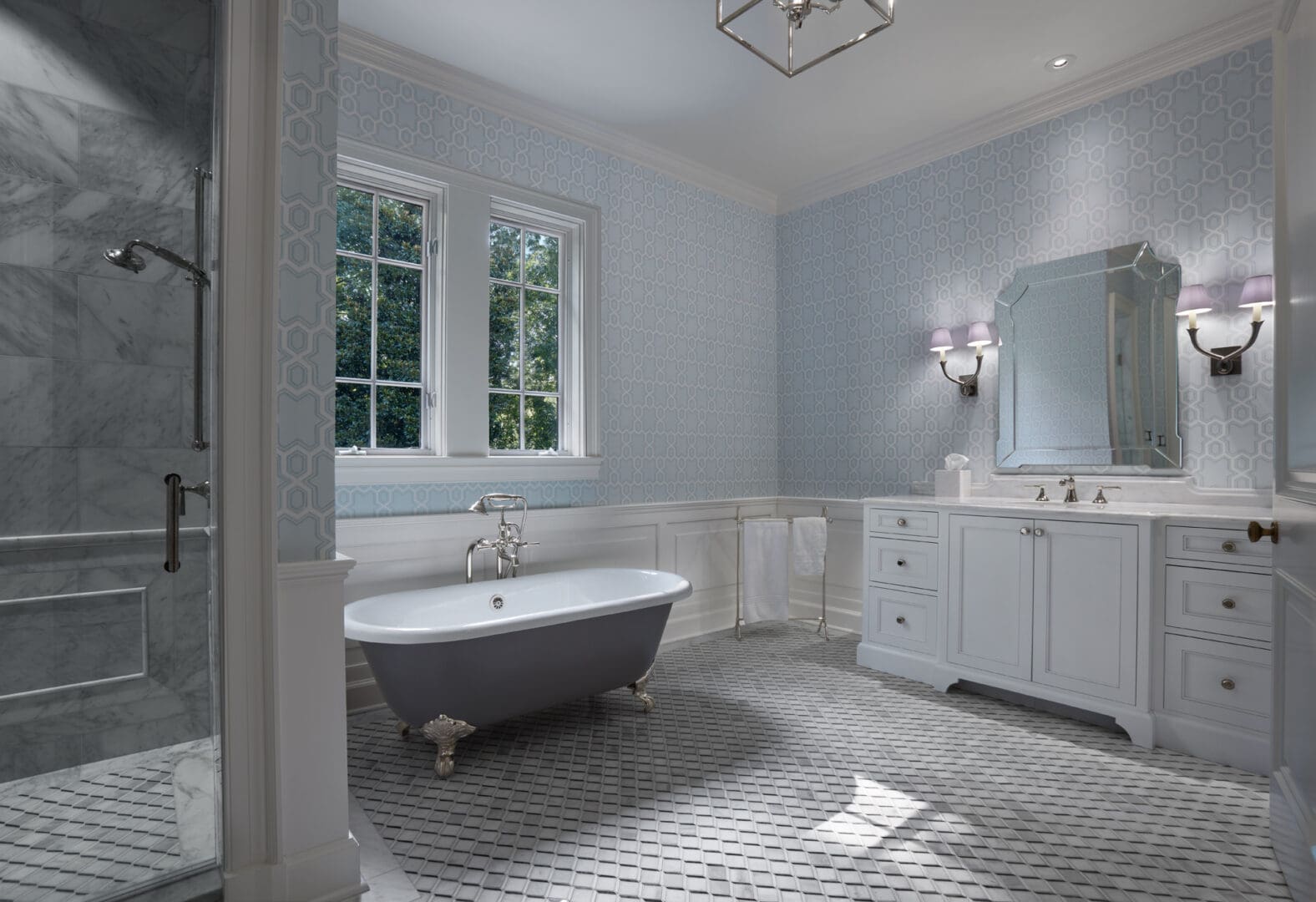 A bathroom with two sinks and a tub.