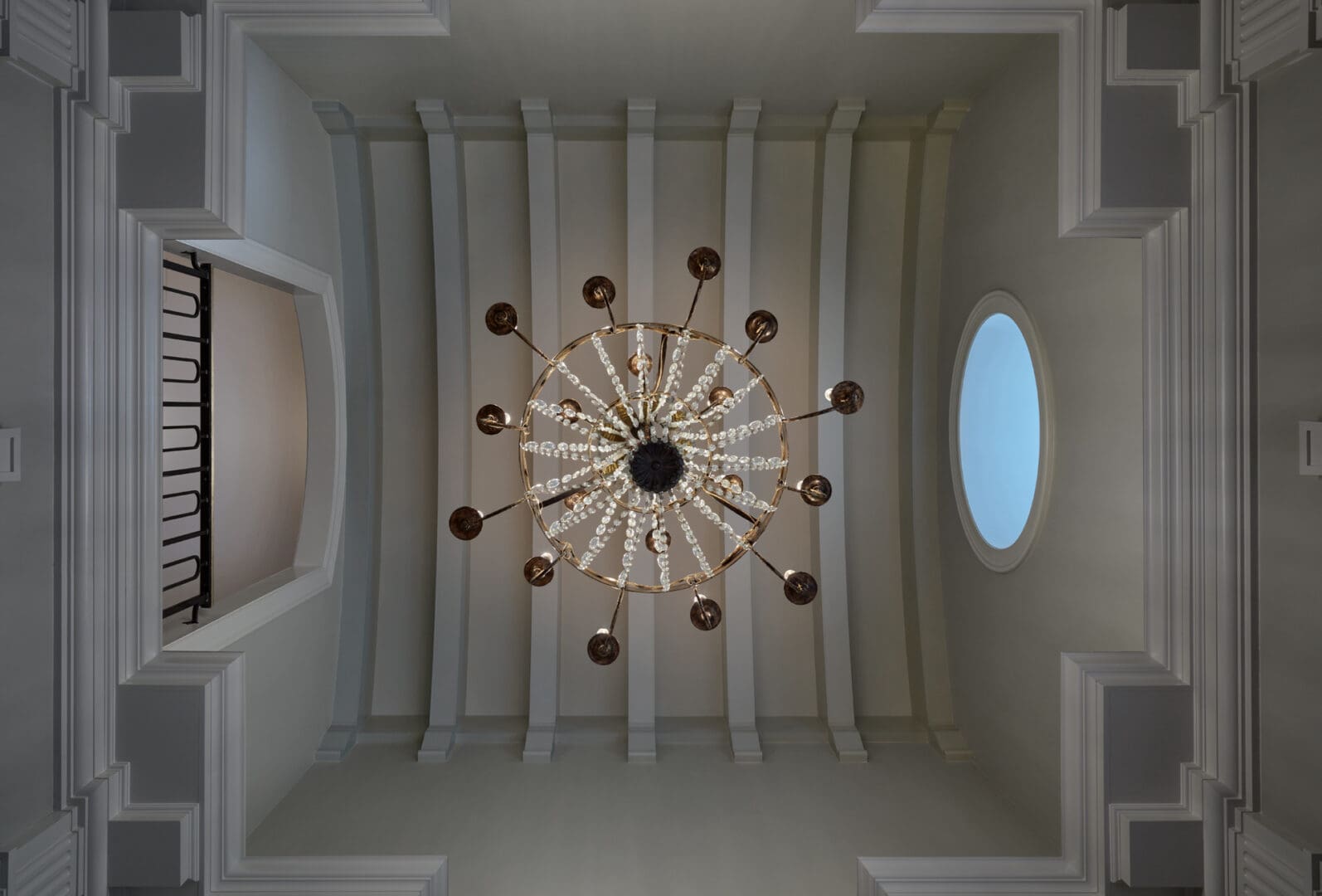 A chandelier in the middle of an empty room.