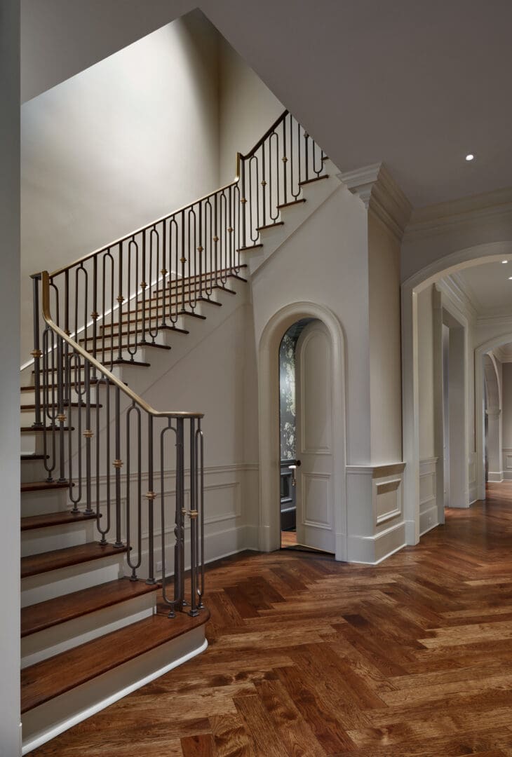 A large hallway with stairs and a door.