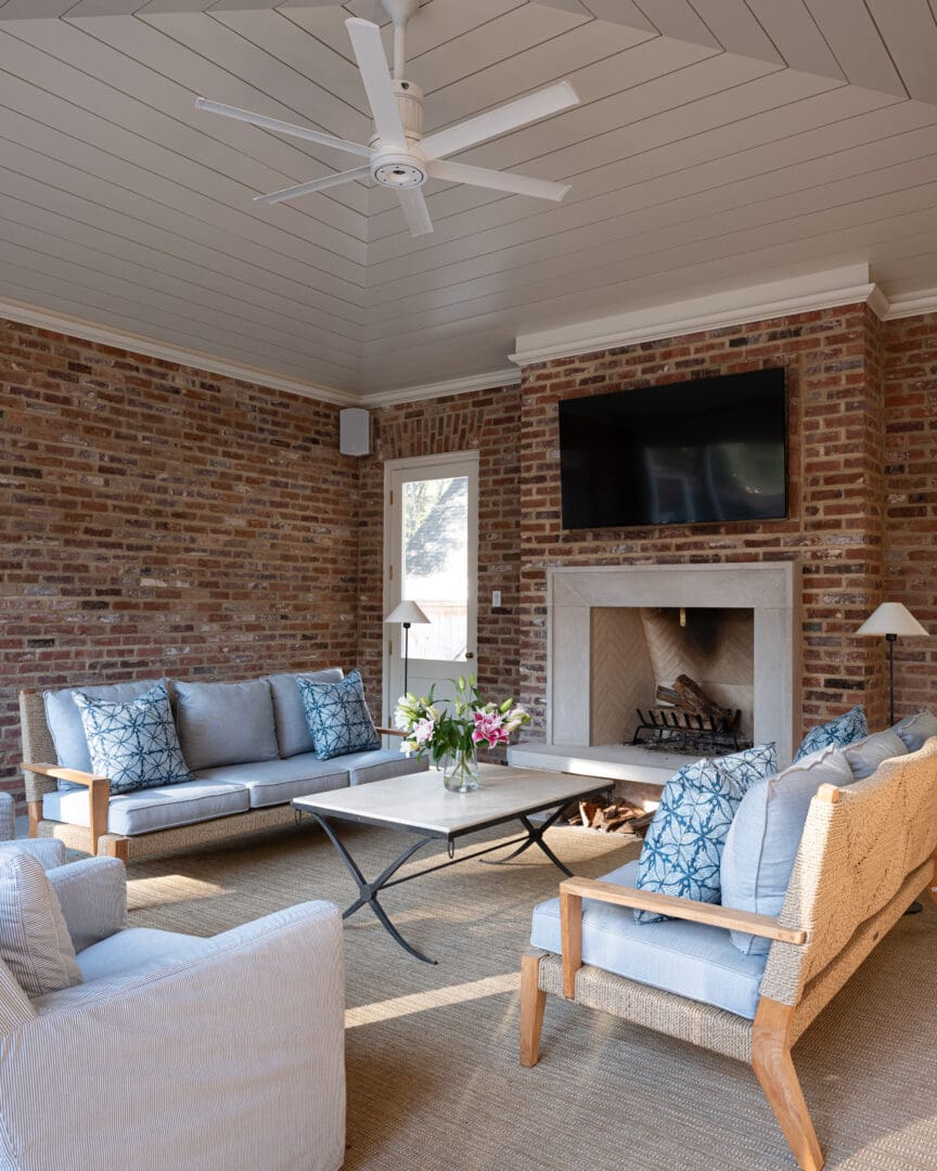 A living room with couches, chairs and a fireplace.